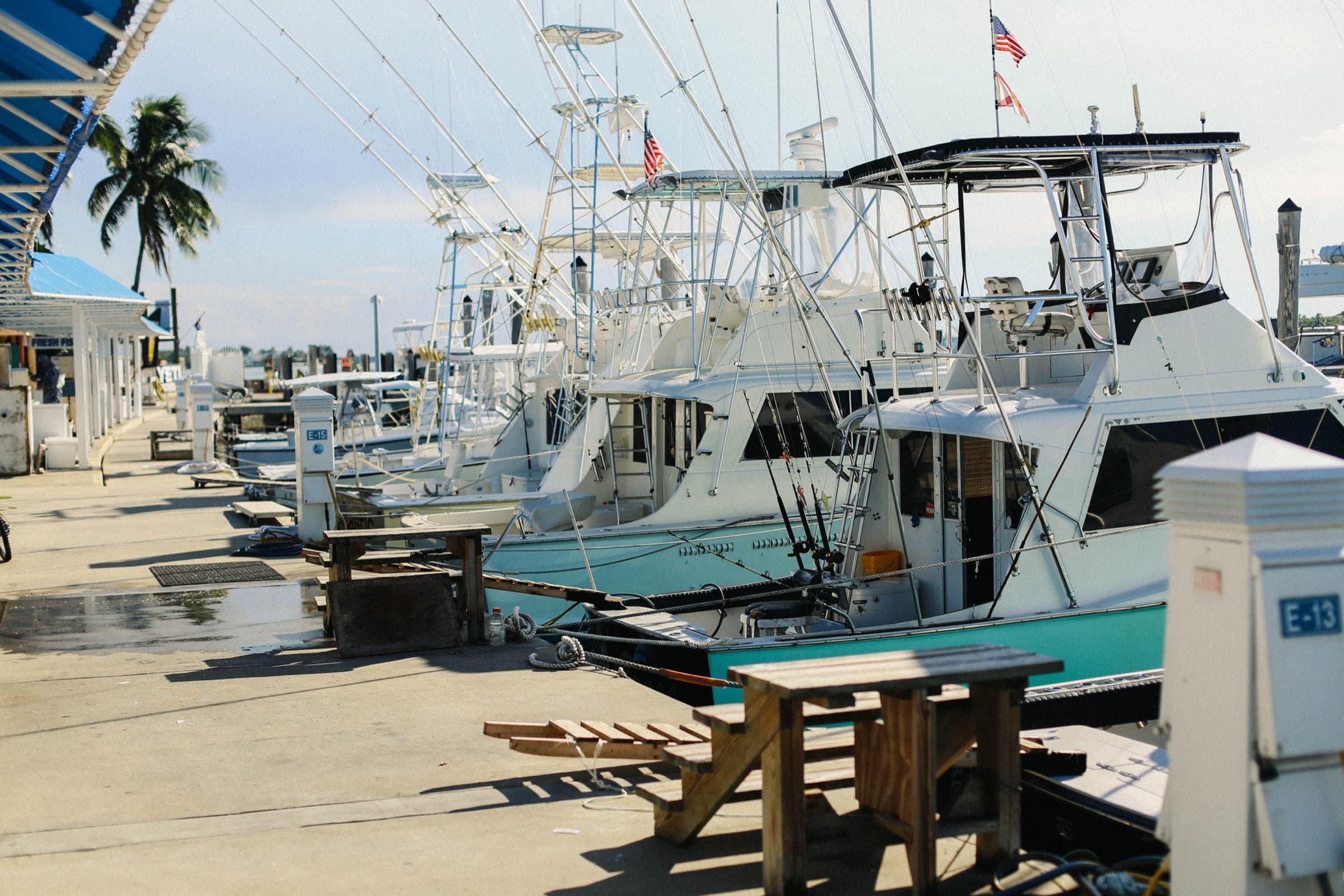 Sportfishing boats tied up along a marina dock in early light